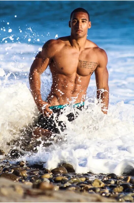 Athletic figure running through breaking ocean waves